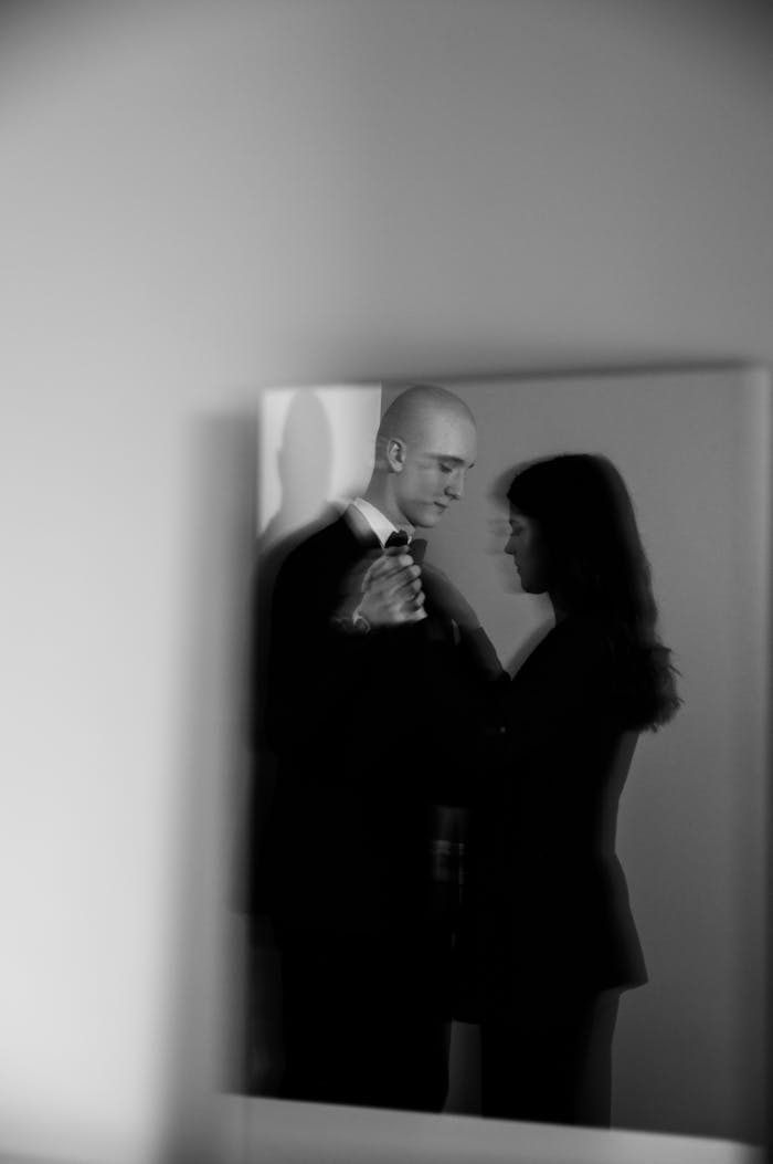 about-us-02 A refined black and white photo capturing a couple dancing, reflected in a mirror.